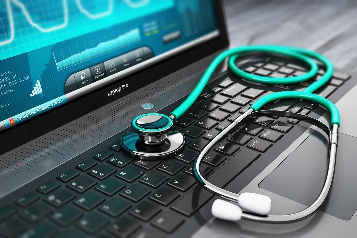 A stethoscope kept on the keyboard of a laptop